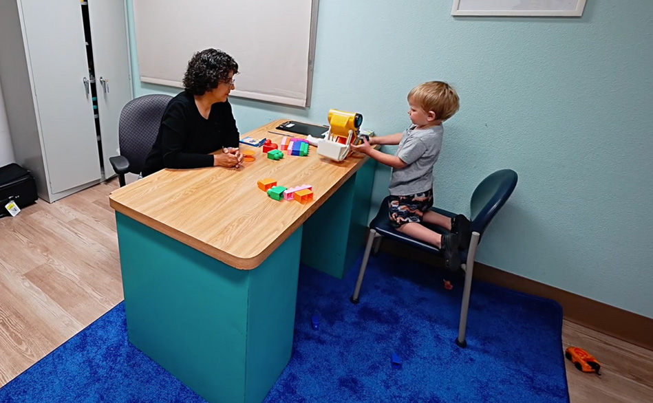 Photo of an developmental evaluation between a child and care coordinator